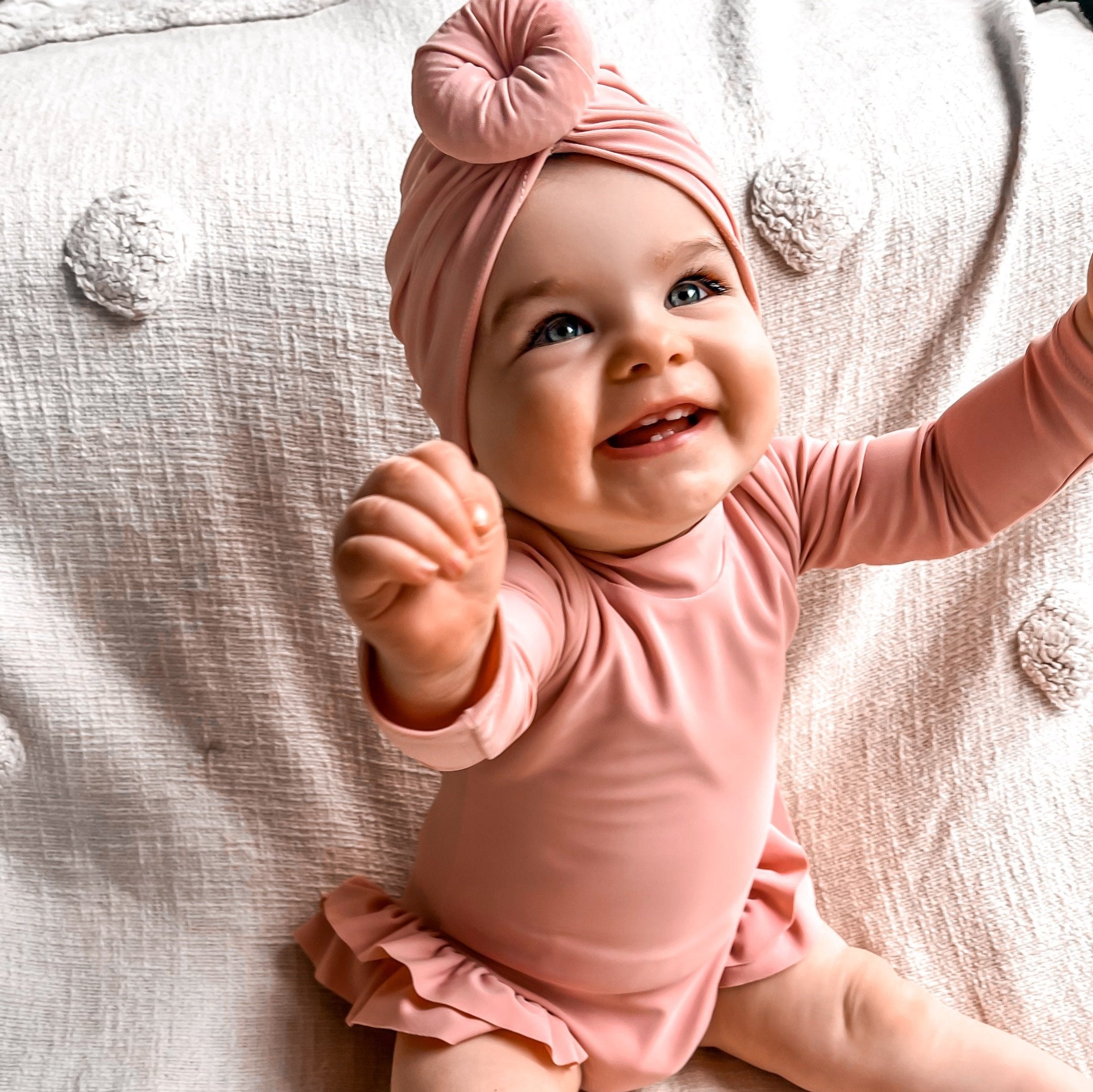 Baby girl in a nappy change snaps pink long sleeve swimsuit