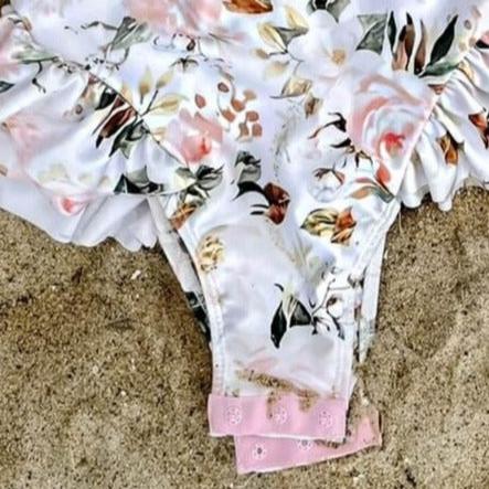 girls swimsuit on the sand that has nappy change snaps