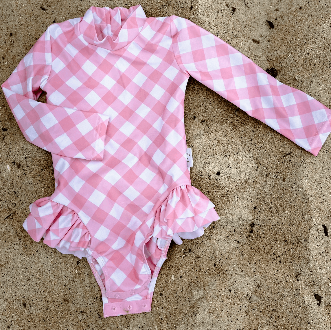 A pink gingham swimsuit with change snaps in sizes from newborn, toddler and school age