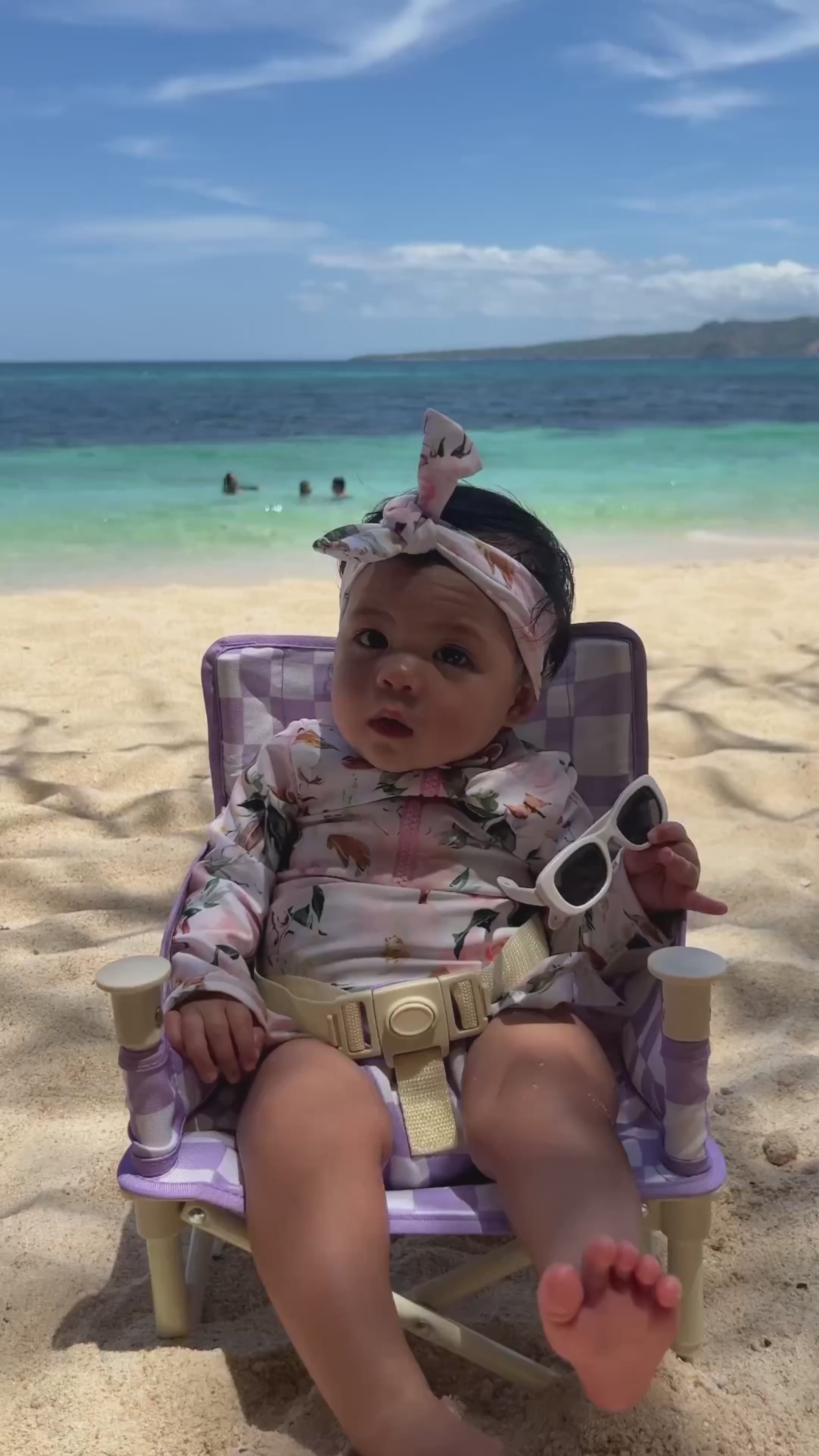 video of newborn baby girl at the beach in a premium swimsuit with nappy change snaps